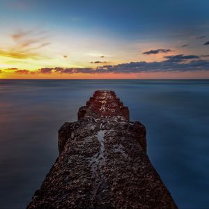 Preview wallpaper breakwater, sea, skyline, sunset