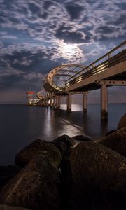 Preview wallpaper bridge, arches, pilings, sea, rocks, twilight