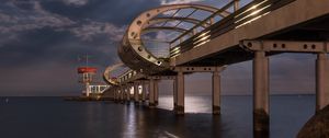 Preview wallpaper bridge, arches, pilings, sea, rocks, twilight
