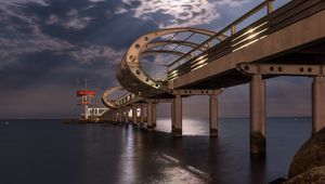 Preview wallpaper bridge, arches, pilings, sea, rocks, twilight