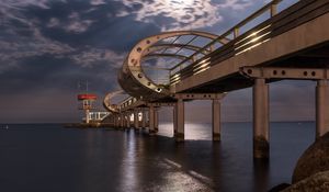 Preview wallpaper bridge, arches, pilings, sea, rocks, twilight