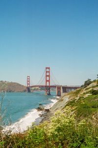 Preview wallpaper bridge, architecture, rocks, sea, bushes