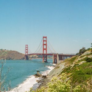 Preview wallpaper bridge, architecture, rocks, sea, bushes