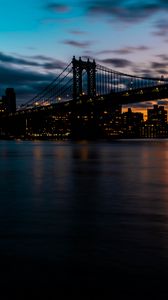 Preview wallpaper bridge, city, coast, sunset, dusk, dark