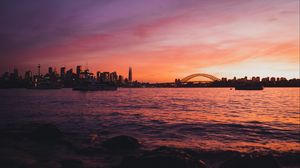 Preview wallpaper bridge, city, sunset, sea, waves