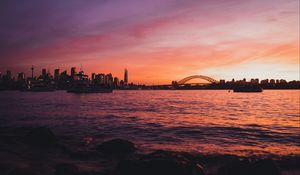 Preview wallpaper bridge, city, sunset, sea, waves
