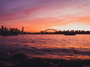 Preview wallpaper bridge, city, sunset, sea, waves