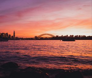 Preview wallpaper bridge, city, sunset, sea, waves