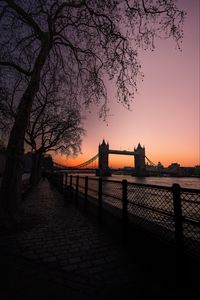 Preview wallpaper bridge, city, water, trees, sunset, embankment, dark