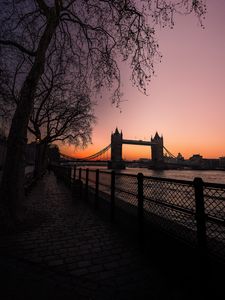 Preview wallpaper bridge, city, water, trees, sunset, embankment, dark