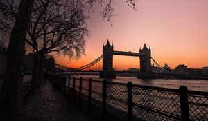 Preview wallpaper bridge, city, water, trees, sunset, embankment, dark