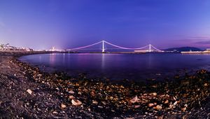 Preview wallpaper bridge, coast, stones, pebbles, shells, twilight