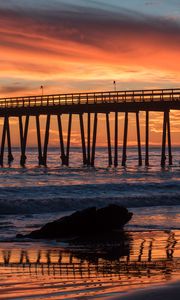 Preview wallpaper bridge, construction, sea, stones, sunset