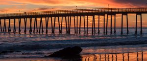 Preview wallpaper bridge, construction, sea, stones, sunset