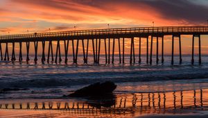 Preview wallpaper bridge, construction, sea, stones, sunset