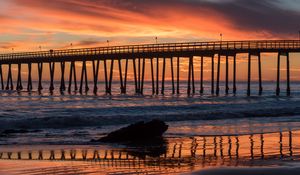 Preview wallpaper bridge, construction, sea, stones, sunset