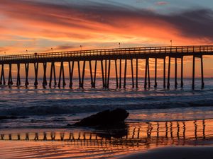Preview wallpaper bridge, construction, sea, stones, sunset
