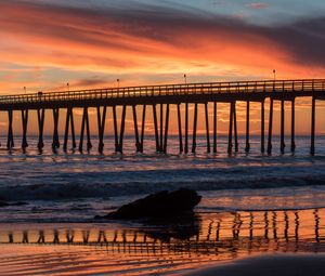 Preview wallpaper bridge, construction, sea, stones, sunset
