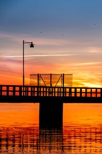 Preview wallpaper bridge, construction, water, sunset, dark