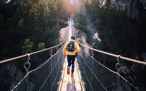 Preview wallpaper bridge, man, mountains, sunlight, switzerland