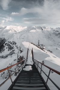 Preview wallpaper bridge, mountains, snow, peak, mountain range