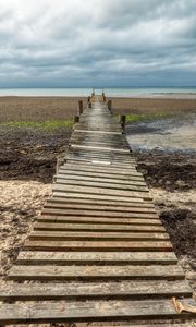 Preview wallpaper bridge, pier, beach, sea, horizon, clouds, sky, landscape