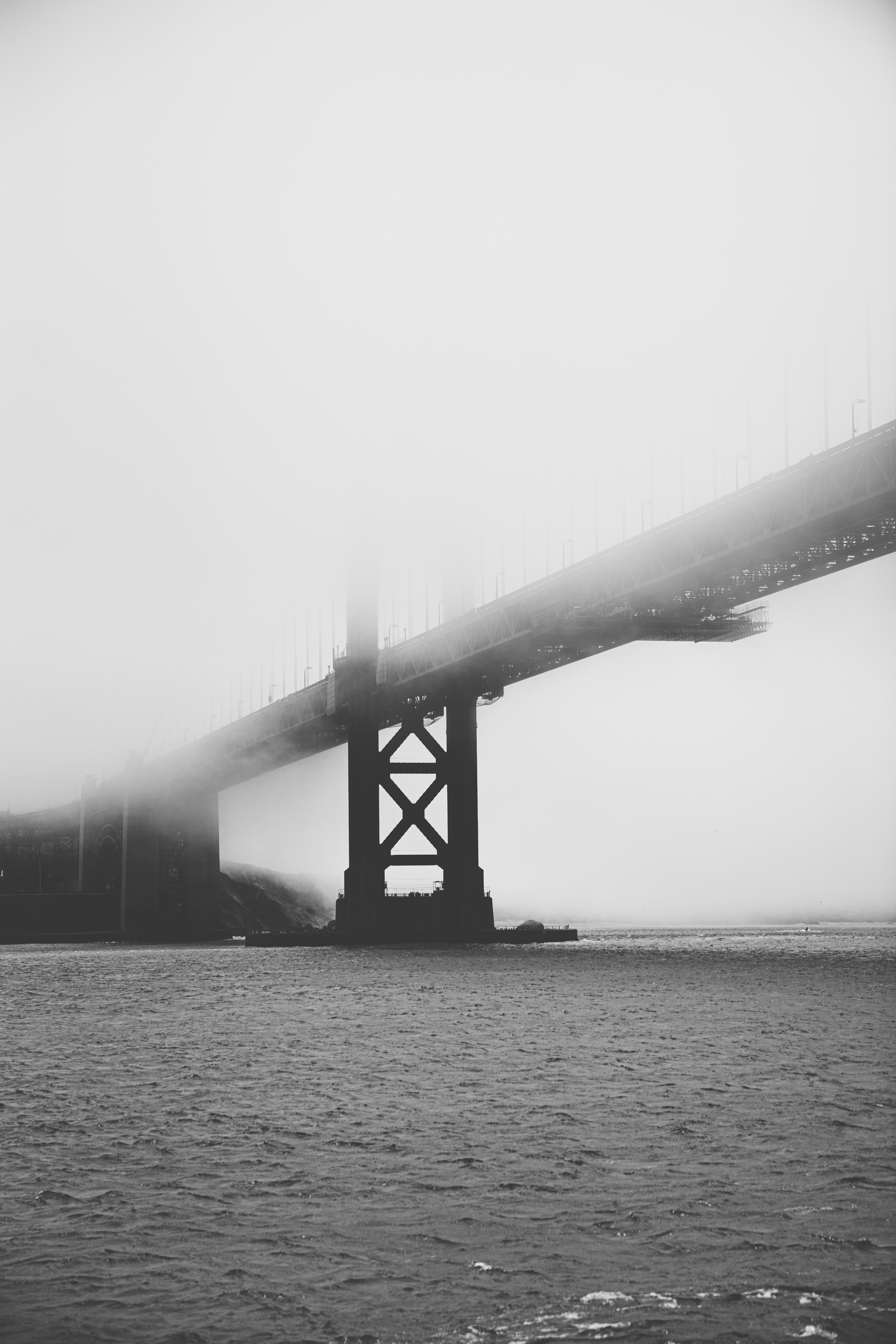 Download wallpaper 2160x3240 bridge, pilings, fog, sea, black and white ...