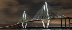 Preview wallpaper bridge, pilings, lights, glow, river, night