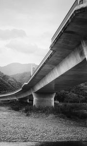 Preview wallpaper bridge, pilings, river, bw, mountains