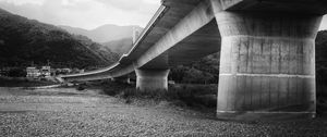 Preview wallpaper bridge, pilings, river, bw, mountains