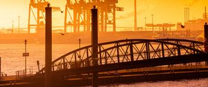 Preview wallpaper bridge, pilings, sea, twilight