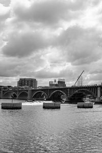 Preview wallpaper bridge, river, clouds, buildings, black and white