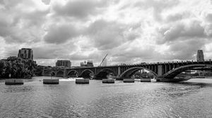 Preview wallpaper bridge, river, clouds, buildings, black and white