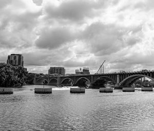 Preview wallpaper bridge, river, clouds, buildings, black and white