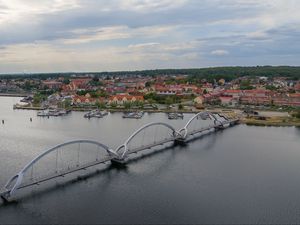 Preview wallpaper bridge, river, houses, pier, boats, sweden