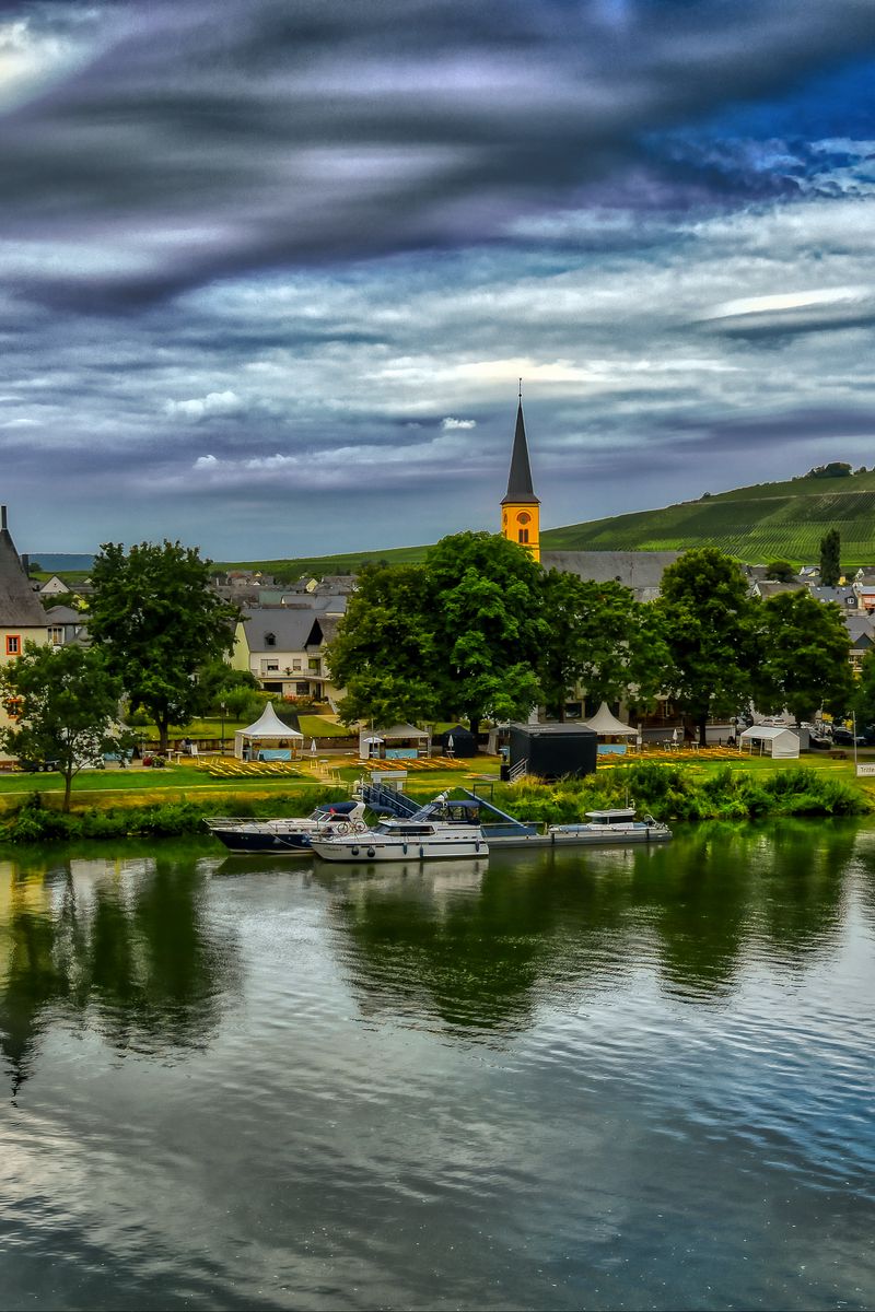 800x1200 Wallpaper bridge, river, motor ships, buildings, trees, clouds, landscape