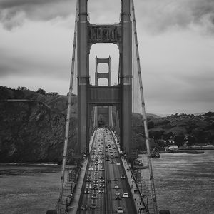 Preview wallpaper bridge, road, cars, river, black and white