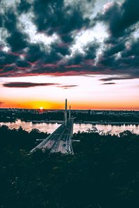 Preview wallpaper bridge, road, city, sunset, sun, trees