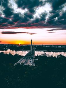 Preview wallpaper bridge, road, city, sunset, sun, trees