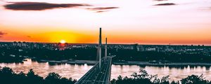 Preview wallpaper bridge, road, city, sunset, sun, trees