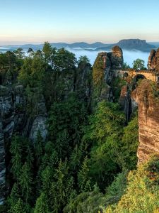 Preview wallpaper bridge, rocks, height, wood, pine, clouds, harmony