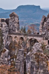 Preview wallpaper bridge, rocks, stone, mountains, arched, architecture