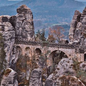 Preview wallpaper bridge, rocks, stone, mountains, arched, architecture