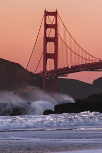 Preview wallpaper bridge, rocks, waves, spray, shore