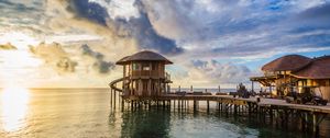 Preview wallpaper bridge, sea, buildings, sun, sunset