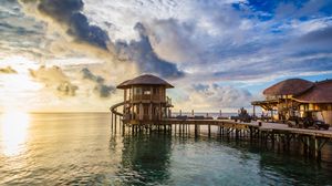 Preview wallpaper bridge, sea, buildings, sun, sunset