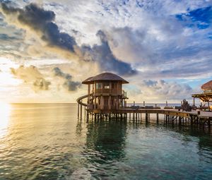 Preview wallpaper bridge, sea, buildings, sun, sunset