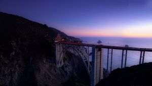 Preview wallpaper bridge, sea, cliff, lights, night, sky, long exposure