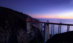 Preview wallpaper bridge, sea, cliff, lights, night, sky, long exposure