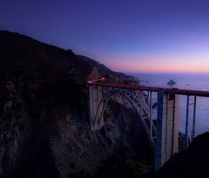 Preview wallpaper bridge, sea, cliff, lights, night, sky, long exposure